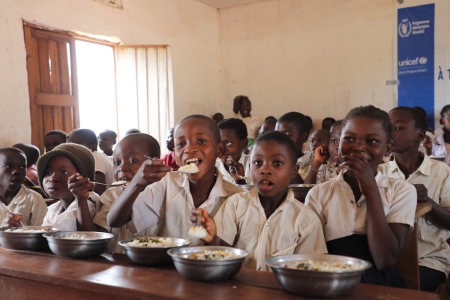 School children eat rice meal in Congo